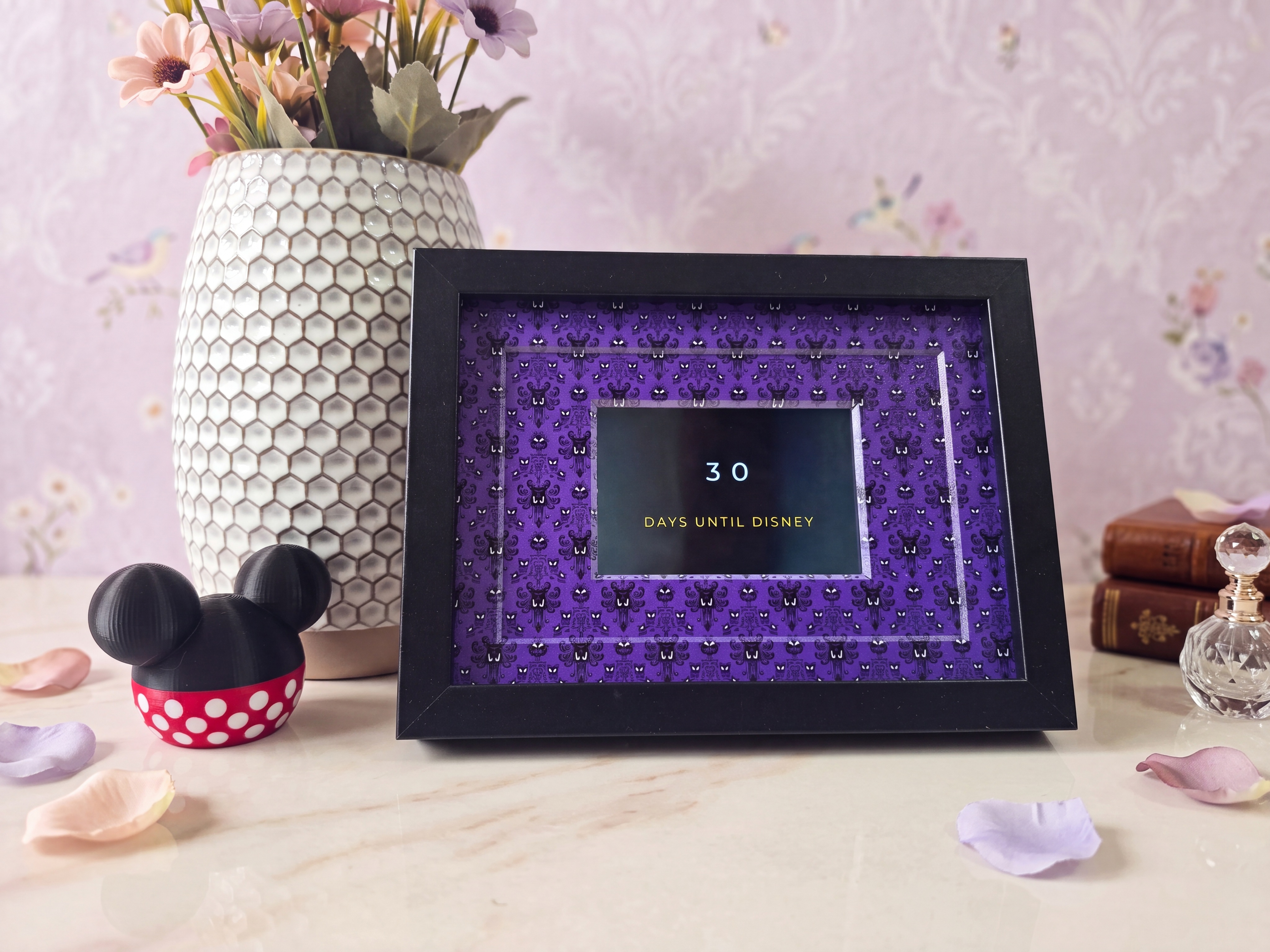 MagicWaits colour touchscreen display in a frame, showing a trip countdown